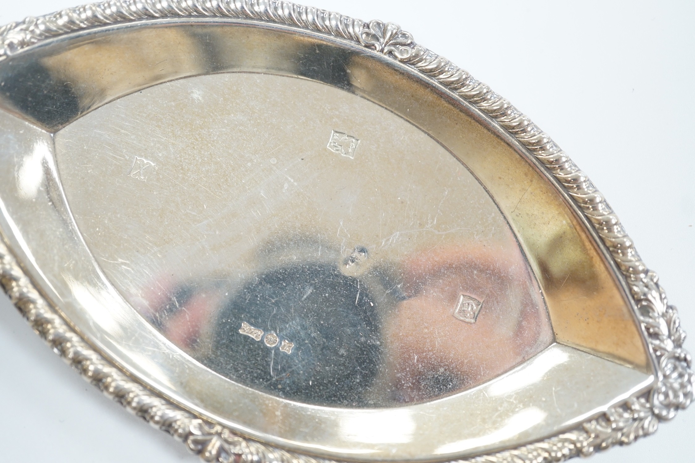 A miniature George V Scottish silver lidded trophy cup, on stand, Edinburgh, 1913, overall 14cm and a George V silver navette shaped dish.
